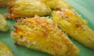 Fiori di zucca ripieni al forno, dorati e croccanti, pronti per essere gustati.