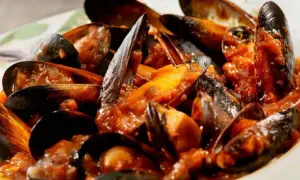 Muscoli alla marinara succulenti, immersi in un sugo rosso ricco e saporito. Un piatto di mare che invita a gustare ogni singolo boccone.