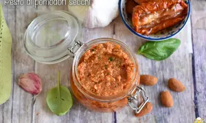 Un vasetto di pesto di pomodori secchi, con mandorle, aglio e basilico, pronto per insaporire i tuoi piatti.