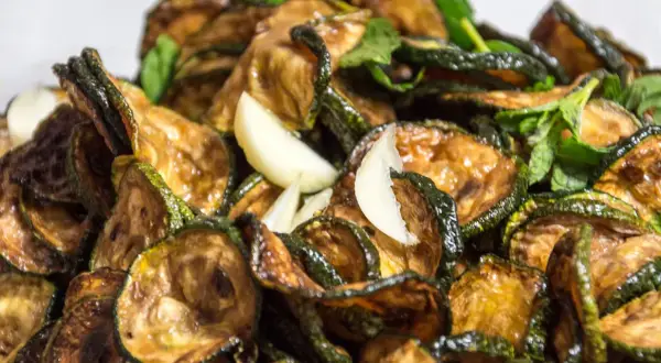 Zucchine alla scapece ricetta: fette di zucchine fritte e marinate con aglio e menta, un contorno saporito e fresco.